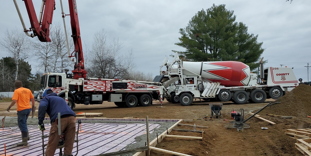 Commercial concrete slab pour with pump truck by RK Masonry Services in Marathon County, WI